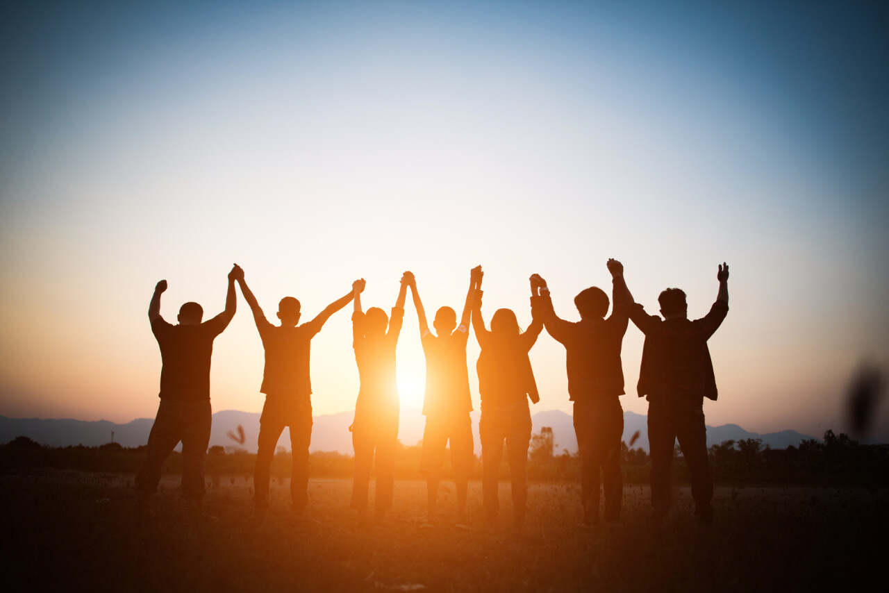 Medium vecteezy silhouette of happy team joining hands in the air 1816638 medium